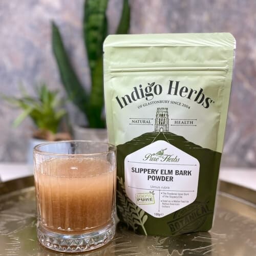 Slippery Elm Bark Powder package next to a glass of drink on a tray.