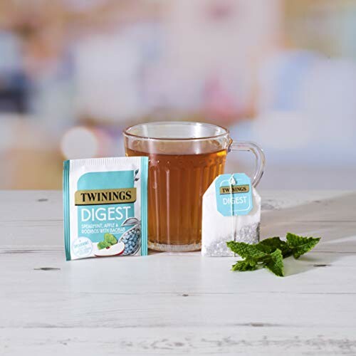 Twinings Digest tea with apple and mint, cup of brewed tea, and mint leaves